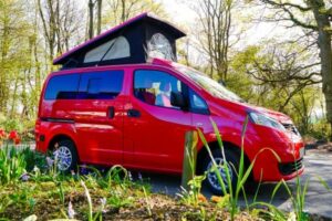 Red Nissan NV200 camper