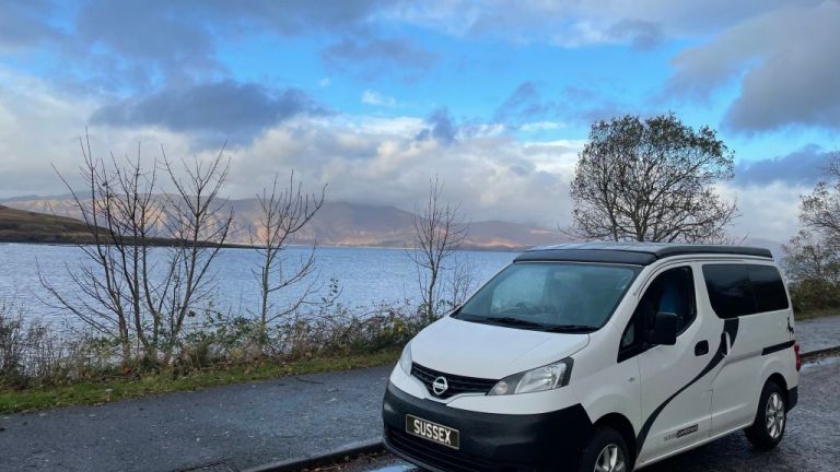 Electric Campervan by a lake