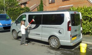 Ella cleaning their campervan