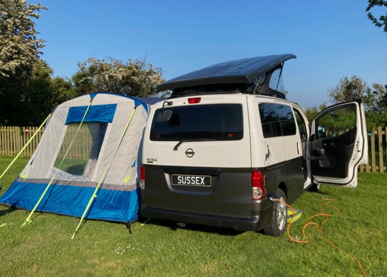black campervan with tent