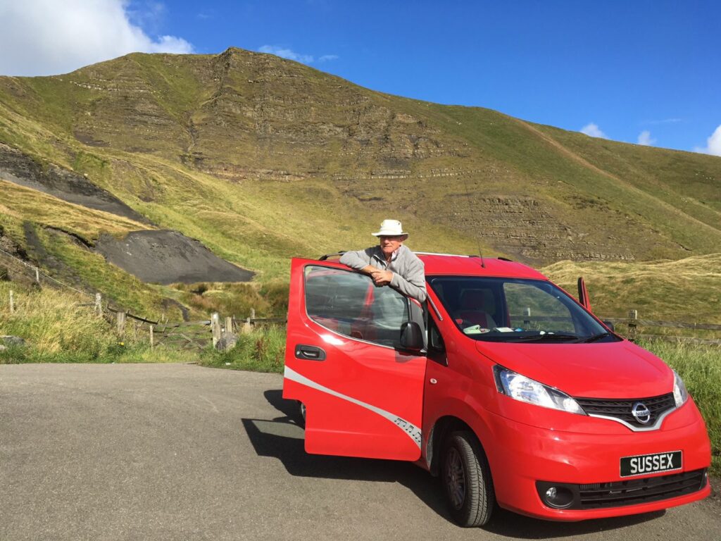 John in hid red campervan