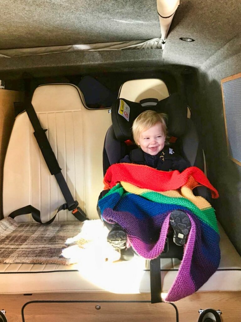 baby Maddie sitting inside the campervan