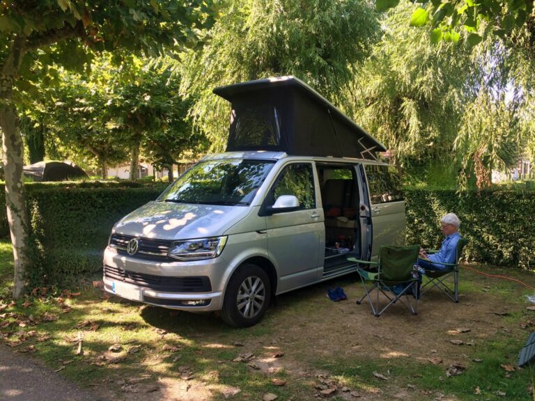 Silver campervan parked in the shade