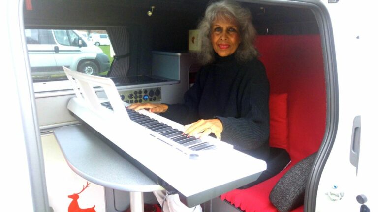 Aprille playing her Yamaha keyboard in their CamperCar