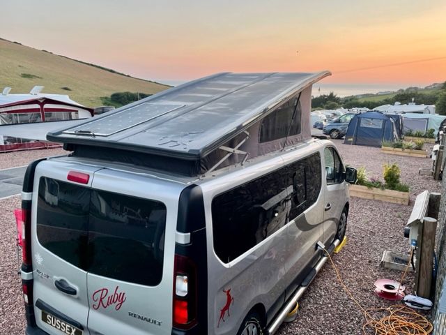 silver campervan parked while sunsets