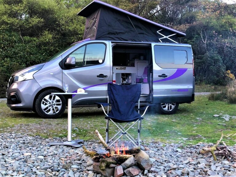 camping with campfire beside the campervan