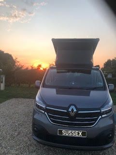 black campervan with sunset background